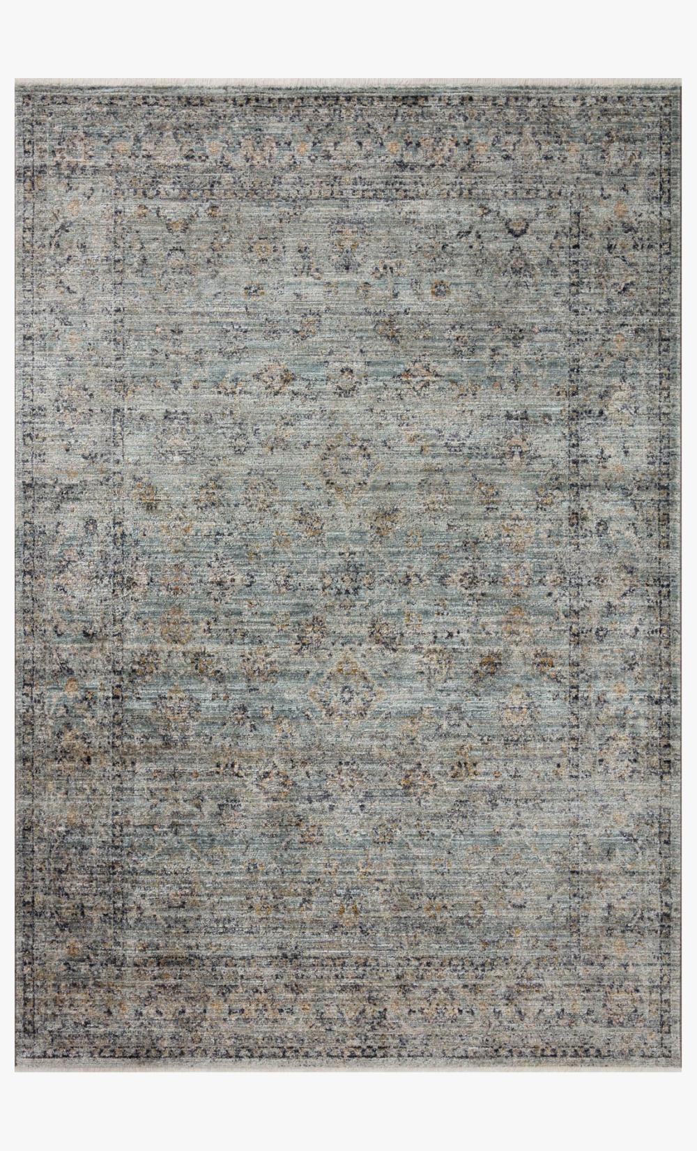 Meticulously power-loomed blue and gold rug with organic dimension, ribbed texture, blending machine craftsmanship with handmade artistry.