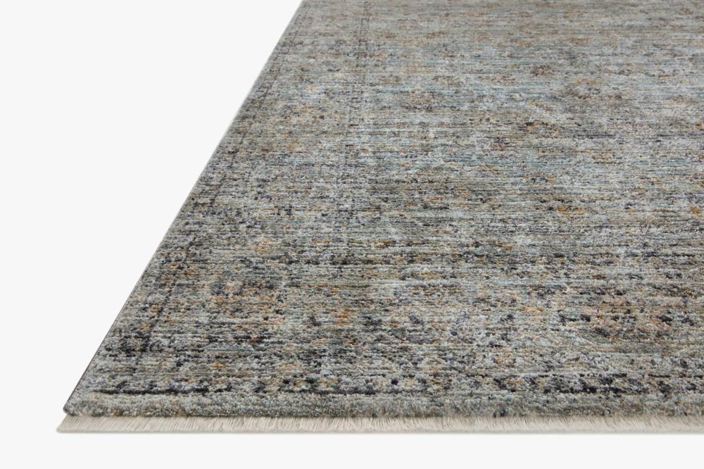 Meticulously power-loomed blue and gold rug with organic dimension, ribbed texture, blending machine craftsmanship with handmade artistry.
