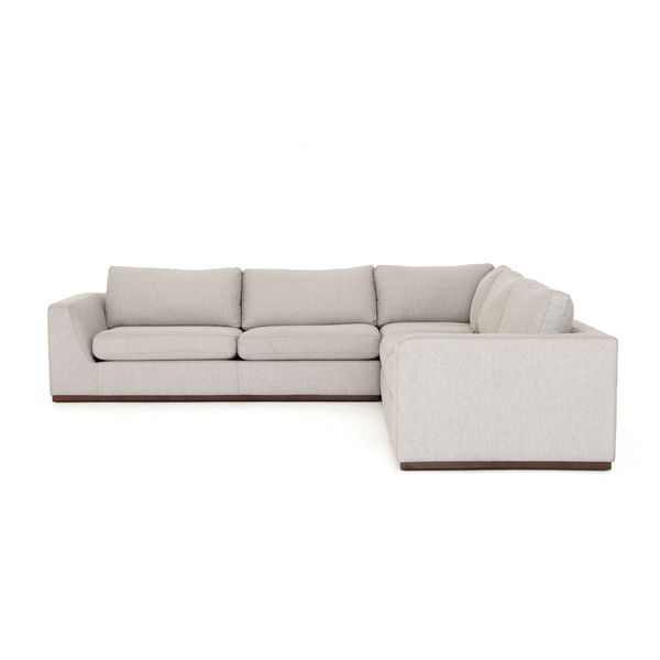 Transform your living room with the Colt 3-Piece Sectional in Aldred Silver. This neutral off-white sofa features a textural poly/linen blend, subtly flared sides, and a sleek plinth-style wooden base, perfect for everyday lounging. Discover more contemporary and transitional furniture on our blog!