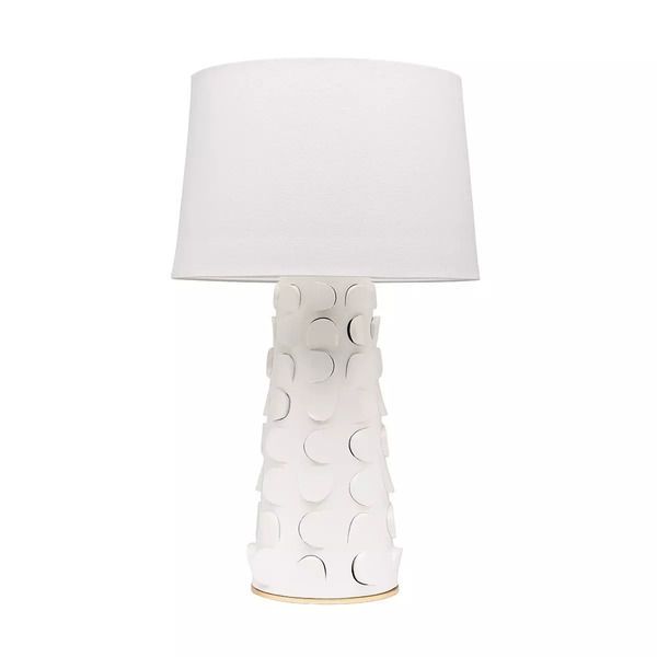 Illuminate your space with the Naomi 1 Light Table Lamp in White/Gold Leaf! With its chunky midcentury modern design and playful post-modern twist, this lamp brings a touch of texture and retro charm to any room. Featuring a Belgian linen shade and a glamorous two-tone finish, it's the perfect statement piece to elevate your home decor.